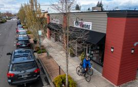 cyclists riding on sidewalk in downtown Canby near Bike store. Photo credit: Joey Hamilton