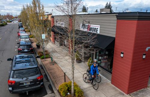 cyclists riding on sidewalk in downtown Canby near Bike store. Photo credit: Joey Hamilton