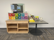 Table with colorful cabinet.