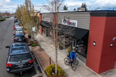 cyclists riding on sidewalk in downtown Canby near Bike store. Photo credit: Joey Hamilton