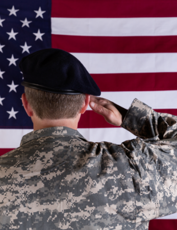 soldier facing US flag