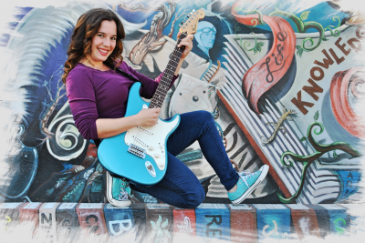 woman holding an electric guitar
