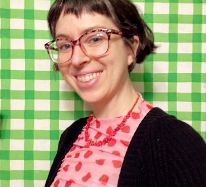 green and white checkered background with smiling artist looking at camera