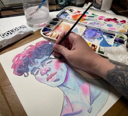 close-up of artist painting a pastel-colored portrait of a peaceful person's face