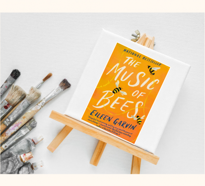 Picture of Tiny art canvas with book jacket of book "Music of the Bees" and paint brushes