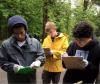 Youths writing on clipboards